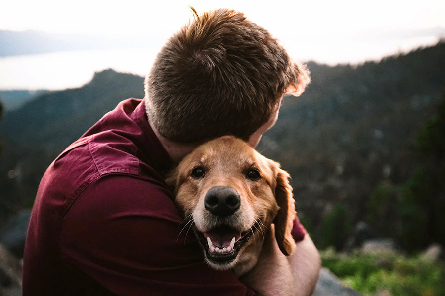 A man and his dog covered by Embrace Pet insurance.
